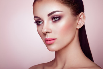 Fototapeta premium Beautiful Young Woman with Clean Fresh Skin. Perfect Makeup. Beauty Fashion. Eyelashes. Cosmetic Eyeshadow. Highlighting. Cosmetology, Beauty and Spa
