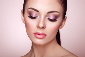 Beautiful Young Woman with Clean Fresh Skin. Perfect Makeup. Beauty Fashion. Eyelashes. Cosmetic Eyeshadow. Highlighting. Cosmetology, Beauty and Spa - obrazy, fototapety, plakaty
