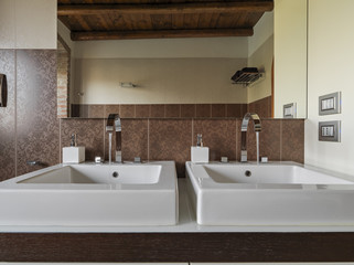 modern bathroom interior in the foreground the countertop washbasin and the taps