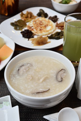 Mushroom meat porridge served with side dish.