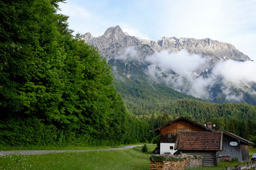 alpine cabin in front of stunning mountain panorama