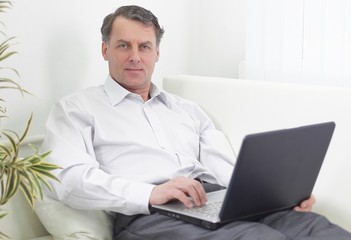 businessman with laptop works in the room