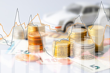 Euro coins in pile on Euro banknotes with charts and car, for background. Germany