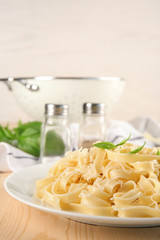 Plate of delicious pasta with cheese on table