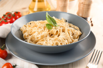 Plate of delicious pasta with cheese on table