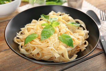 Plate of delicious pasta with cheese on table