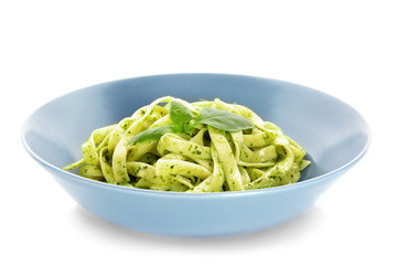 Plate of delicious pasta with pesto sauce on white background