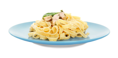 Plate of delicious pasta with chicken fillet on white background