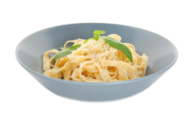 Plate of delicious pasta with cheese on white background