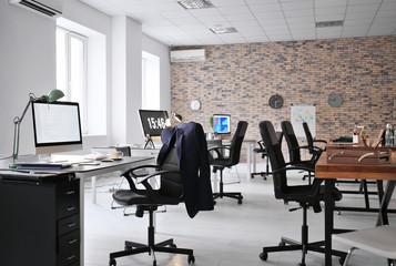 Office interior with tables and armchairs. Workplace design