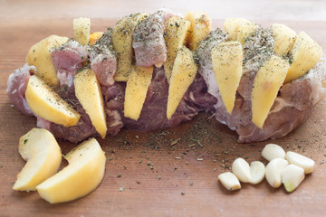 Raw pork neck steak stuffed with pumpkin on wood table