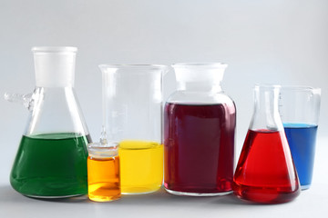 Chemical glassware with samples on light background