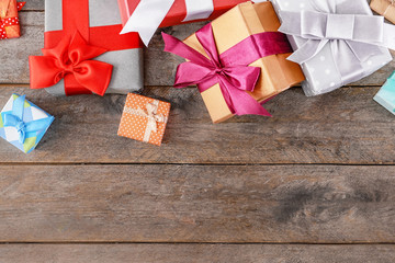 Different gift boxes on wooden background, top view