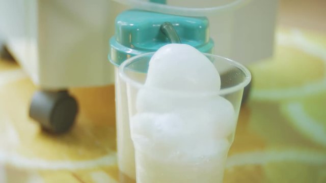 Woman make oxygen cocktail with device for oxygen scum. Oxygen cocktail for woman. Woman make oxygen cocktail with device for oxy scum