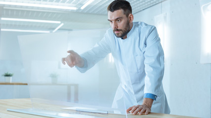 In the Futuristic Laboratory Male Scientist Works on His Transparent Computer Display Great for Mock-up Template, like Chroma Key.