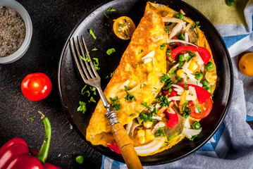 Healthy breakfast food, Stuffed egg omelette with vegetable, dark concrete background copy space...