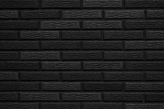 Black stone brick wall pattern and seamless background