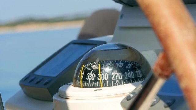 Closeup on navigating instruments behind steering wheel of sailing boat. Filmed on sailing trip in Croatia in slow motion hd.