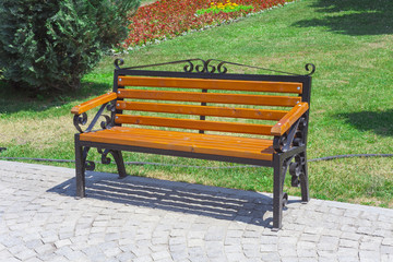 empty wooden bench in the green park