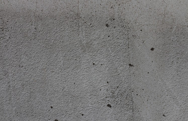 Gray background of concrete with pits and indentations.