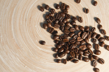 coffee beans scattered on a bamboo board
