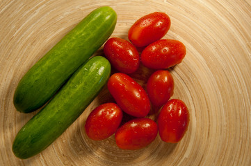 tomatoes and cucumbers on the board