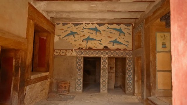 Tilt shot revealing of a room painted with frescoes in the Minoan Palace of Knossos, Heraklion, Crete, Greece