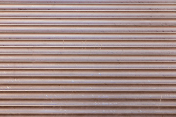 Venetian Jalousie blinds, with warm orange sun flares coming through, soft closeup.