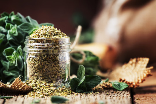 Fototapeta Dried and fresh oregano, vintage wood background, rustic style, selective focus