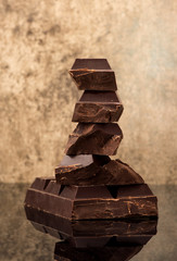 Block and stack chocolate on a dark marble background