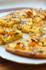 Pizza with pumpkin on wooden background