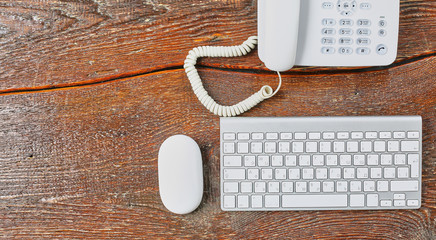 Laptop, tablet and notebook are on a wooden table