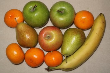 Fruit background from apples, bananas and tangerines.