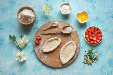 The cook makes pies with fresh strawberries. Homemade cake.