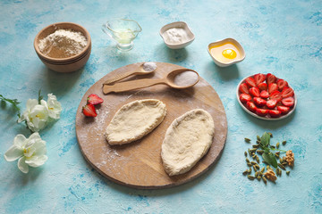 The cook makes pies with fresh strawberries. Homemade cake.