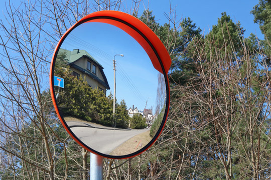 A round convex mirror is installed at the village crossroads for safety