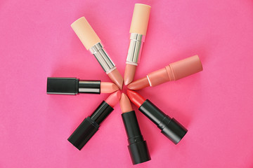 Obraz premium Flat lay composition with different lipsticks on color background. Professional cosmetic