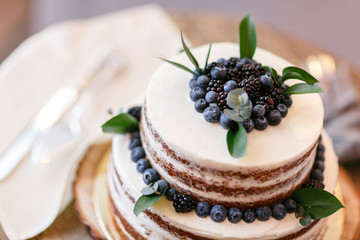 Wedding or birthday cake with berries. Sweet pie on banquet in restaurant.