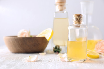 Fototapeta na wymiar Bottle with essential oil on wooden table