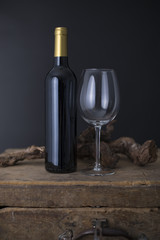 Wine bottle on a Old wood case on a black Background