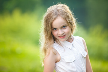 close up portrait of little beautiful stylish kid girl on green background
