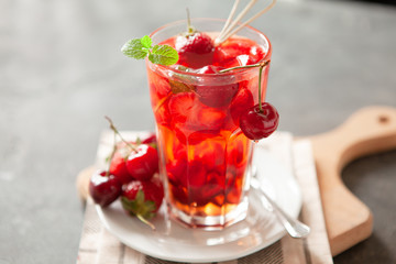 Red compote juice with fresh cherry and strawberry