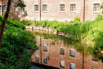 Fototapeta na wymiar Castle wall reflection in the moat