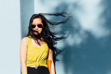 Portrait of young woman outdoors, hair blowing in breeze