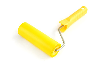 Yellow roller for wallpaper isolated on white background.