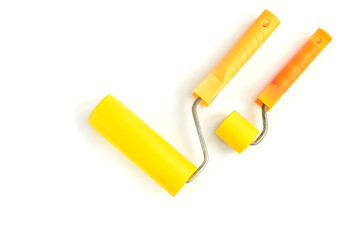 Yellow roller for wallpaper isolated on white background.