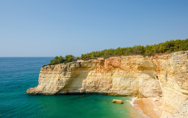 View of the golden limestone cliffs and Atlantic ocean near Benagil village. Algarve, District...