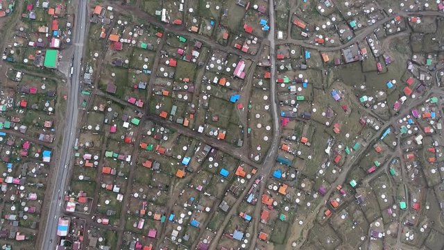 Aerial drone shot from top view dozen of yurts and a road in Mongolia ulan Bator