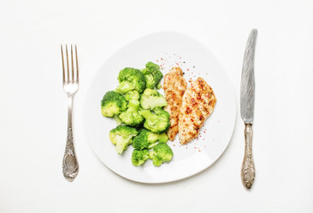 Grilled chicken and broccoli, healthy lunch, white background, top view