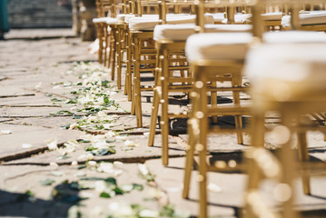 Chairs for a wedding ceremony and flowers on the ground